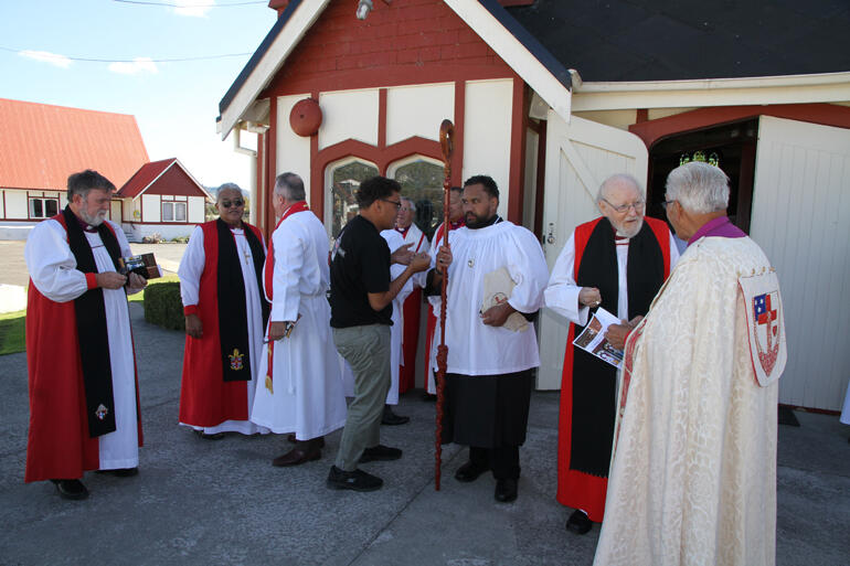 Bishop Ngarahu Katene chats with old friend Bishop George Connor as clergy prepare to enter St Faith's Ohinemutu.